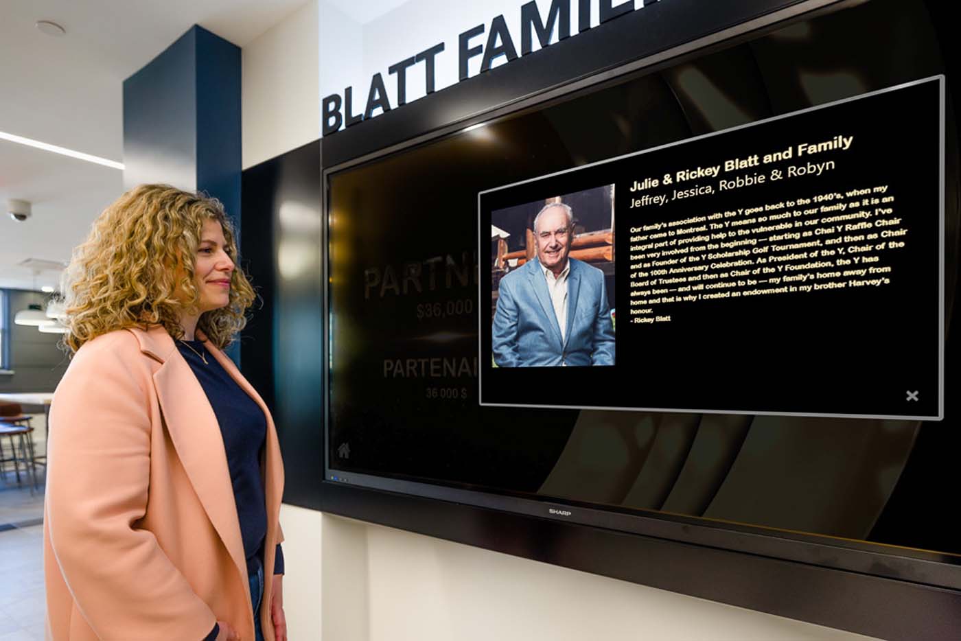 Woman looking at Digital Donor wall